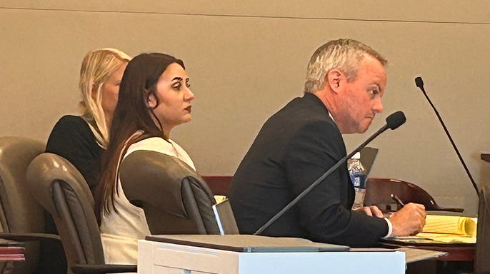 Leigha Mumby sits between attorney Reid Hart and a legal assistant during jury selection in Bunnell, Florida