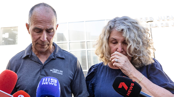 Martin and Debra Robinson speak to reporters, with Debra holding a tissue to her face