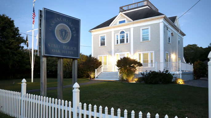 The Martha's Vineyard State Police barracks at dusk, with lights on