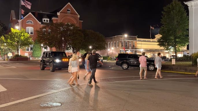 image shows people walking outside