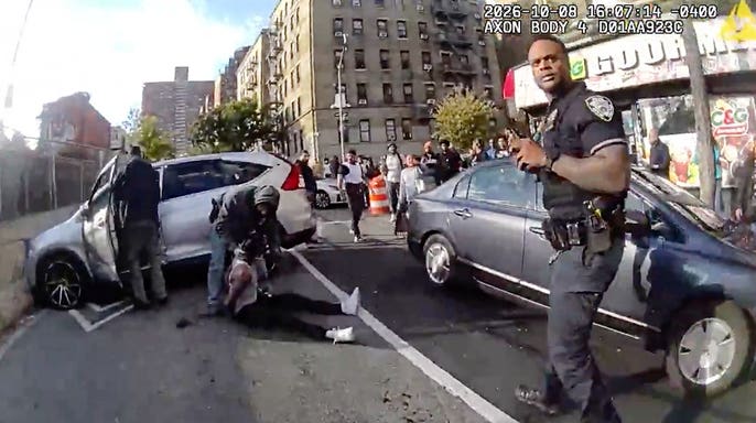 Oscar Belgal lies on the ground as law enforcement personnel tend to him.