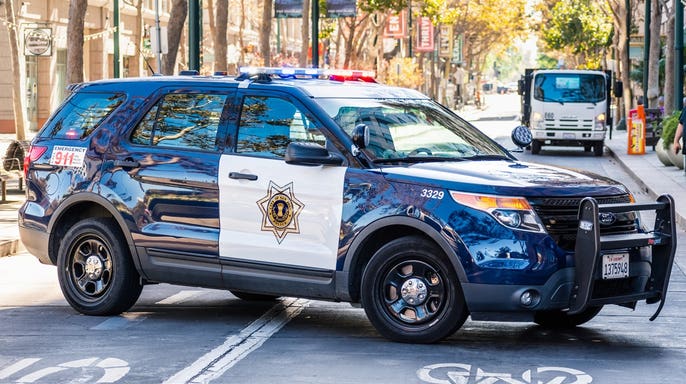 San Jose police car blocking a street in the downtown area, and providing support during an event