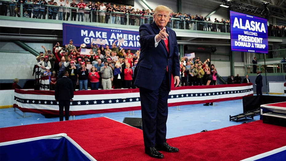 Trump signs pardons for Alaska diesel mechanics onstage during rally touting major energy deals