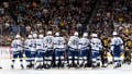 PITTSBURGH, PA - APRIL 06:  Referee Steve Kozari is surrounded by players while being carted off the ice during the game between the Tampa Bay Lightning and the Pittsburgh Penguins at PPG PAINTS Arena on April 6, 2024 in Pittsburgh, Pennsylvania. (Photo by Joe Sargent/NHLI via Getty Images)