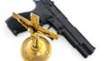 Handgun beside an old brass crucifix